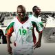 A collage of the Senegal national football team featuring a color photo of Papa Bouba Diop wearing a white, green, and red number 19 jersey in the foreground, with Sadio Mané behind him, surrounded by black-and-white images of legendary moments including former manager Aliou Cissé. Image used for Sportxparte news.