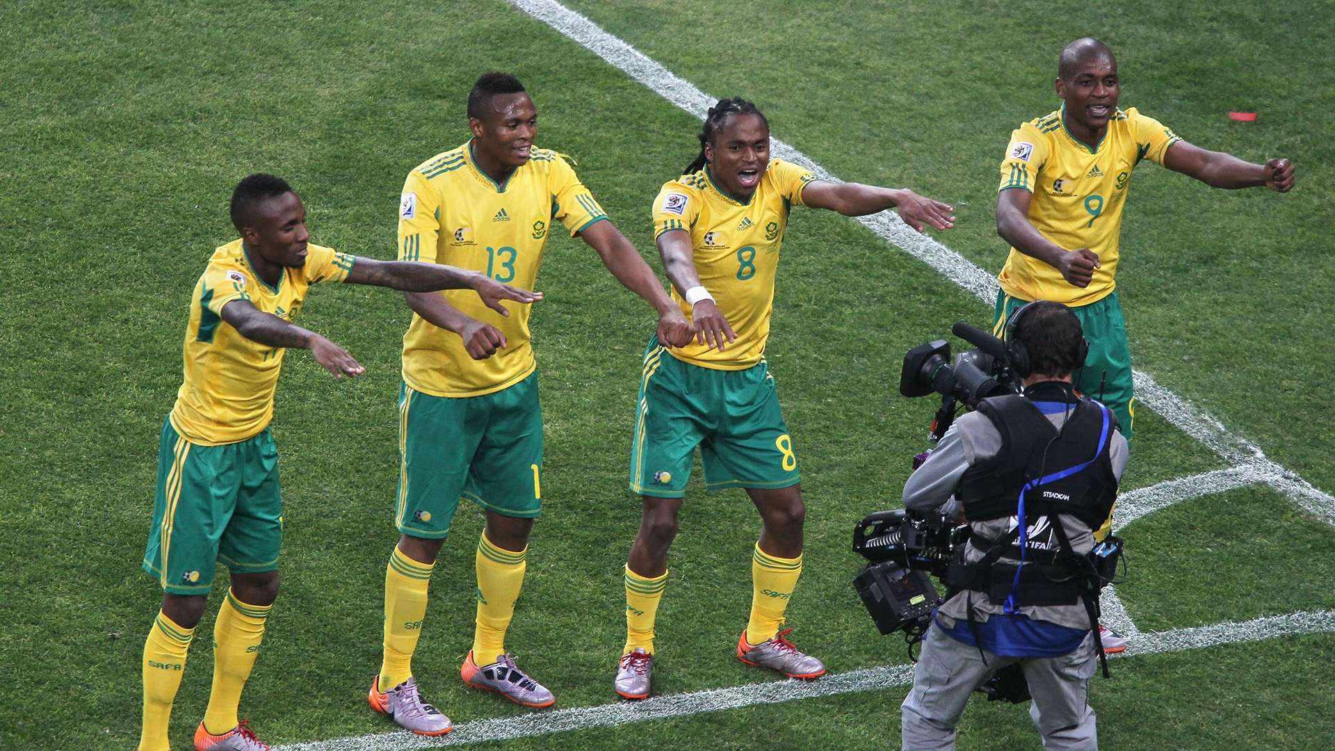 Siphiwe "Shabba" Tshabalala (wearing number 8) and his Bafana Bafana teammates performing their iconic macroarena-style dance celebration. This historic moment followed his spectacular opening goal for South Africa against Mexico during the 2010 FIFA World Cup. Image used for Sportxparte news.