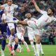Tunisia's Montassar Talbi #3 and Ellyes Skhiri #17 battle mid-air with Japan's Takehiro Tomiyasu #22 for a soccer ball during the 1,000th World Cup match. Image used for Sportxparte news.