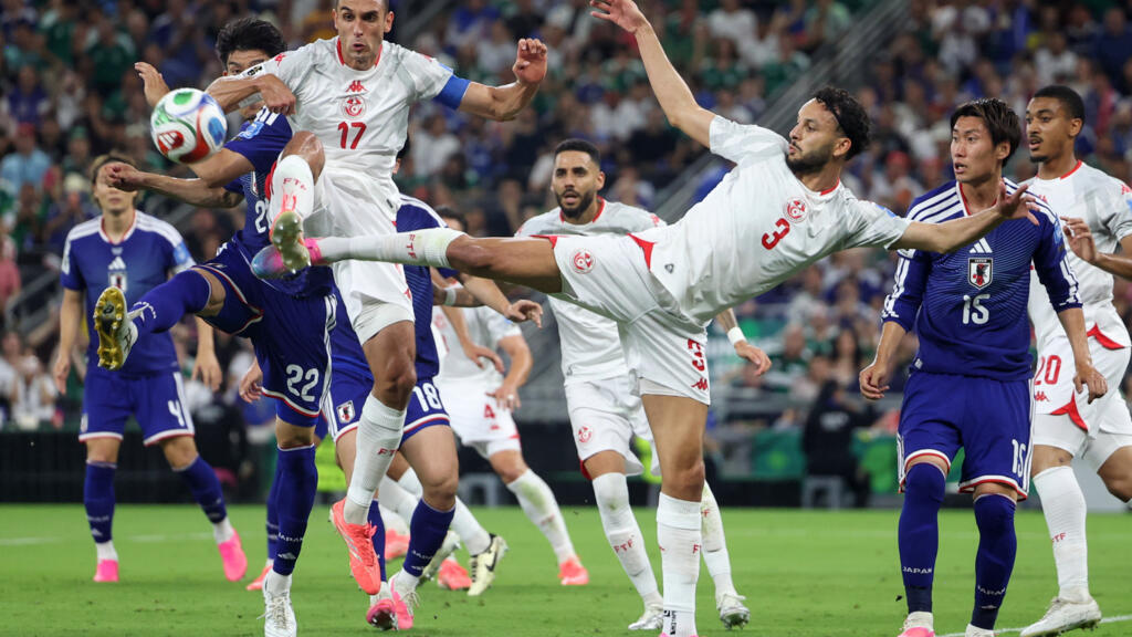 Tunisia's Montassar Talbi #3 and Ellyes Skhiri #17 battle mid-air with Japan's Takehiro Tomiyasu #22 for a soccer ball during the 1,000th World Cup match. Image used for Sportxparte news.