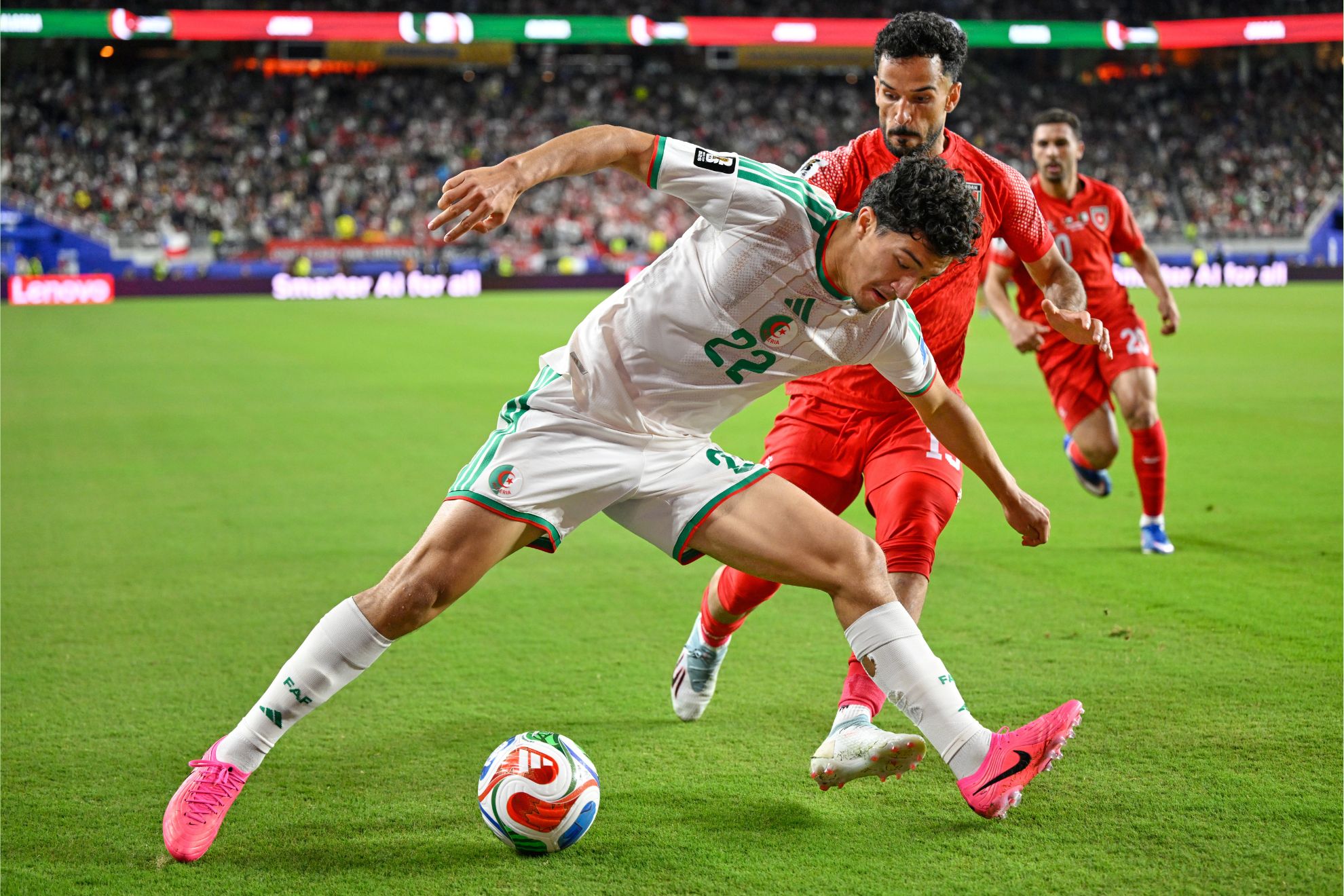 Algerian midfielder Ibrahim Maza protects the ball from Jordanian defender Mahmoud Almardi during a FIFA World Cup group stage match. Image used for Sportxparte news.