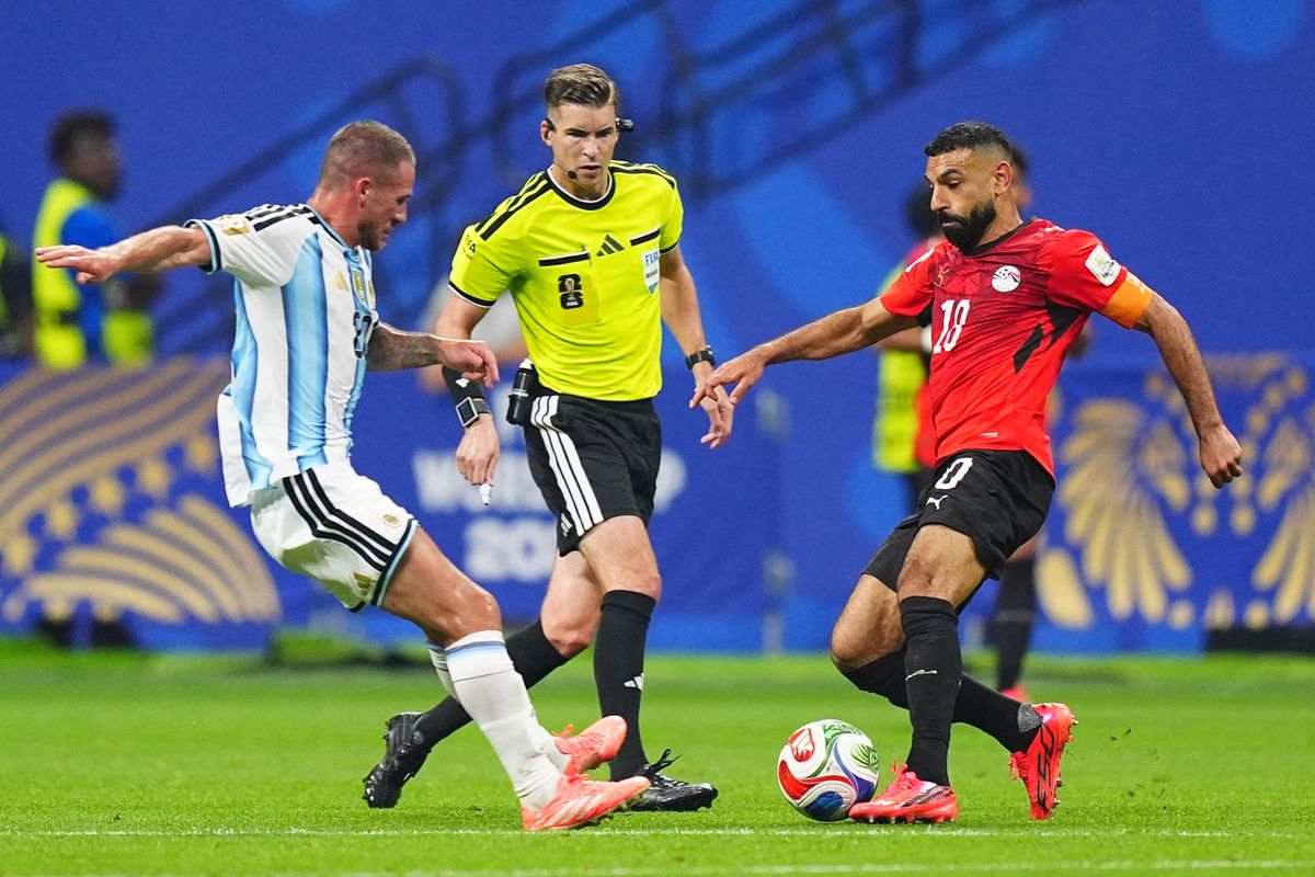 Argentina's Alexis Mac Allister is battling Egypt's Mohamed Salah for the ball during their 2026 World Cup match. Image used for Sportxparte news.