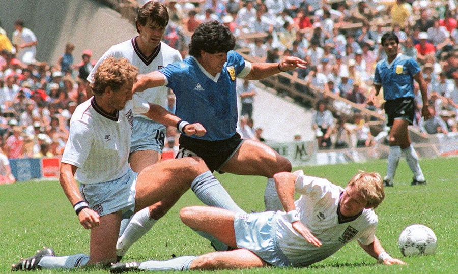 Argentina's legendary captain Diego Maradona slaloming past multiple English defenders during the historic Argentina v England (1986 FIFA World Cup) quarterfinal match. Image used for Sportxparte news.
