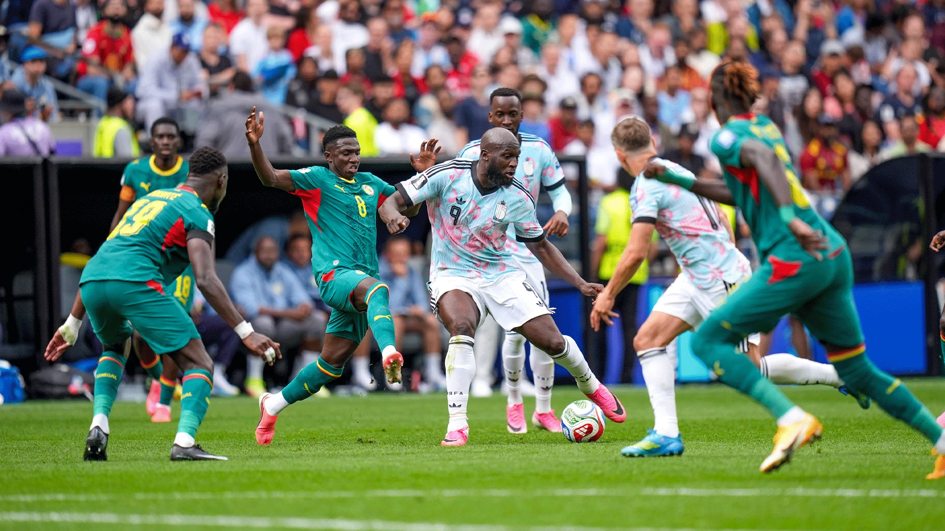 Belgian forward Romelu Lukaku shielding the football against Senegal defenders during a 2026 FIFA World Cup Round of 32 match. Image used for Sportxparte news.