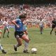Diego Maradona dribbling past English defenders during the iconic Argentina v England quarterfinal match at the 1986 FIFA World Cup. Taken on June 22, 1986, at the Estadio Azteca in Mexico City, this specific moment shows Maradona embarking on his famous solo run to score what was later voted the "Goal of the Century. Image used for Sportxparte news.
