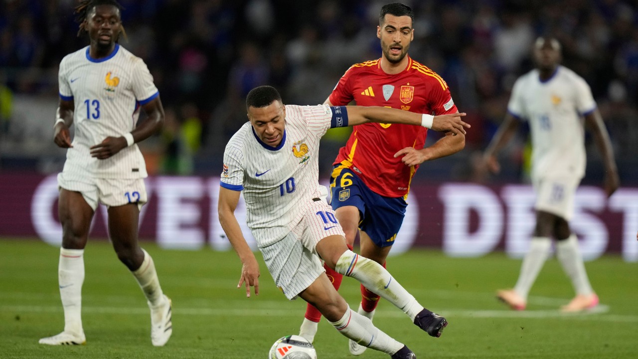 Kylian Mbappe of France dribbling the ball past Spain's Mikel Merino during the UEFA Nations League semifinal match. Image used for Sportxparte news.