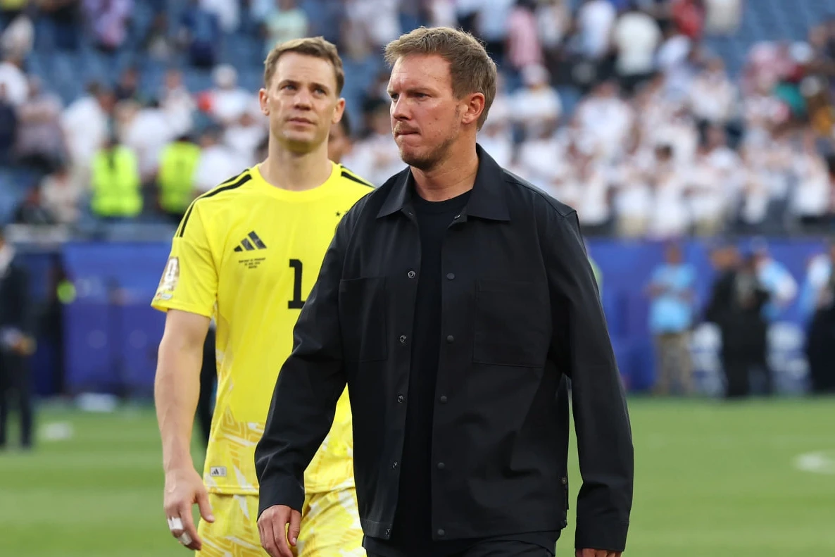 Julian Nagelsmann is the head coach of Germany, shown here reacting after a penalty shootout loss to Paraguay in the 2026 World Cup. Image used for Sportxparte news.