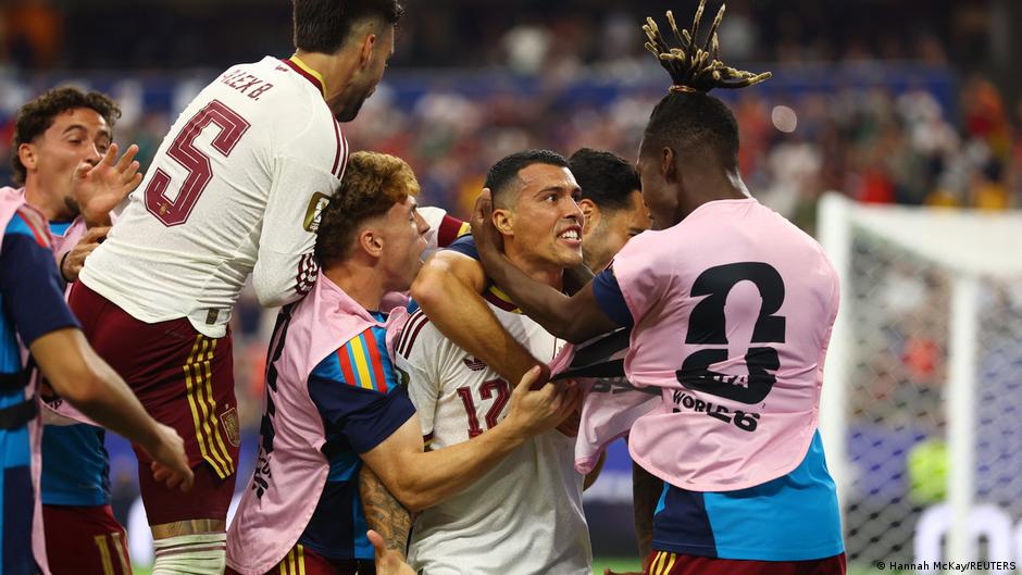 Spain's Pedro Porro (#12) is celebrated by teammates after scoring the second goal in a 2-0 victory over France. The momentous goal secured Spain's spot in the 2026 FIFA World Cup Final. Image used for Sportxparte news.
