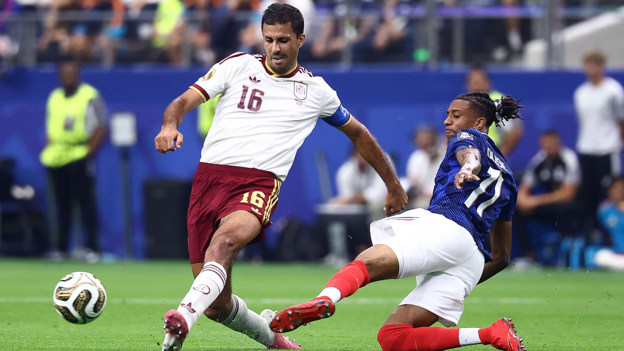 Rodrigo Hernández Cascante (Rodri) wearing a white Spain national team jersey and maroon shorts with "16" in red numbering during the 2026 FIFA World Cup semi-final against France. Image used for Sportxparte news.