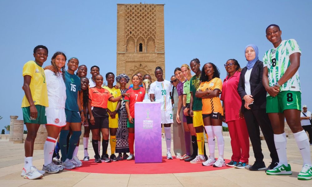Female football players from various national teams posing with the new TotalEnergies CAF Women's Africa Cup of Nations trophy at the Hassan Tower in Rabat, Morocco. Image used for Sportxparte news.