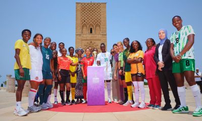 Female football players from various national teams posing with the new TotalEnergies CAF Women's Africa Cup of Nations trophy at the Hassan Tower in Rabat, Morocco. Image used for Sportxparte news.
