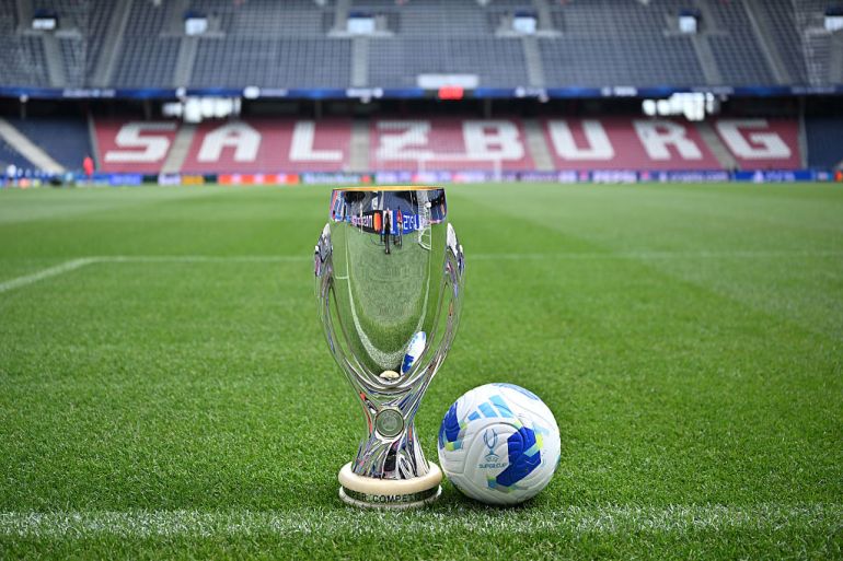 UEFA Super Cup trophy and match ball on the pitch at the Stadion Salzburg in Austria. This serves as the pre-match showcase for the 2026 UEFA Super Cup final. Image used for Sportxparte news.