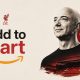 Graphic illustration featuring Amazon founder Jeff Bezos next to the Liverpool FC Liver Bird crest and a red-tinted Anfield stadium, styled with an Amazon marketplace arrow and an orange "Add to Cart" button. Image used for Sportxparte news.