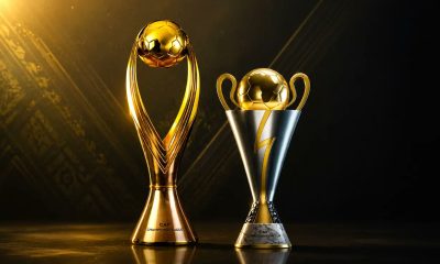 The official golden CAF Champions League trophy next to the silver and gold CAF Confederation Cup trophy on a dark backdrop. Image used for Sportxparte news.