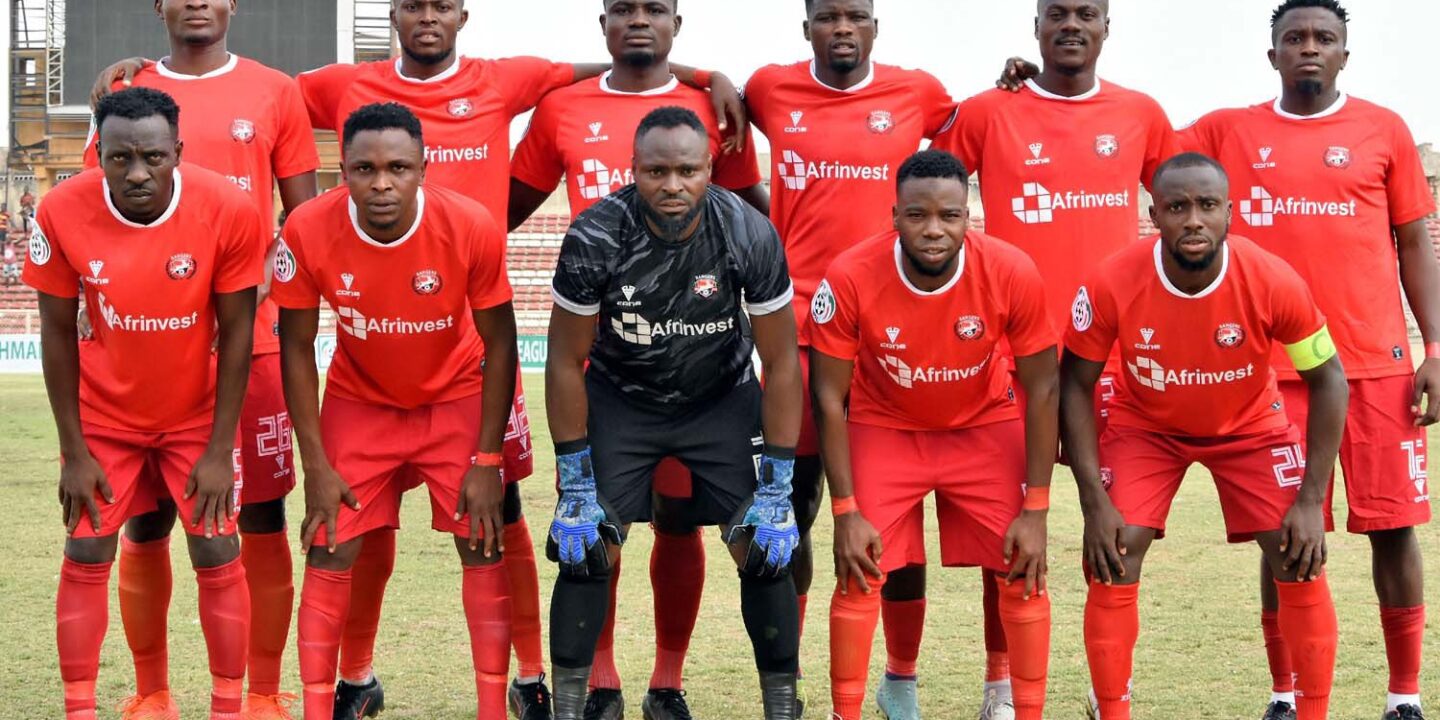 Enugu Rangers International F.C. team lineup posing in red Afrinvest-sponsored kits during a Nigeria Premier Football League match. Image used for Sportxparte news.