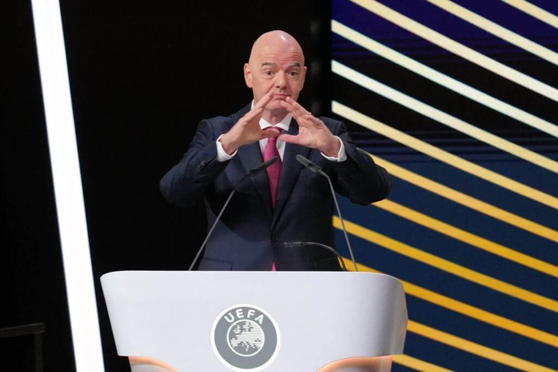 FIFA President Gianni Infantino speaks from a UEFA branded podium during an official football administration summit. Image used for Sportxparte news.