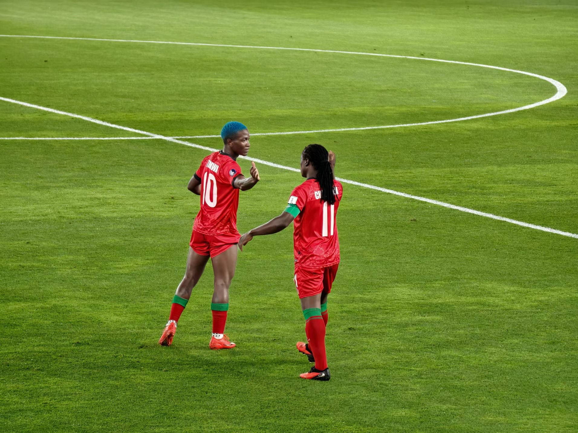 Malawi Scorchers soccer stars Temwa Chawinga and Tabitha Chawinga celebrate a historic victory on the pitch for the Malawi women's national football team. Image used for Sportxparte news.
