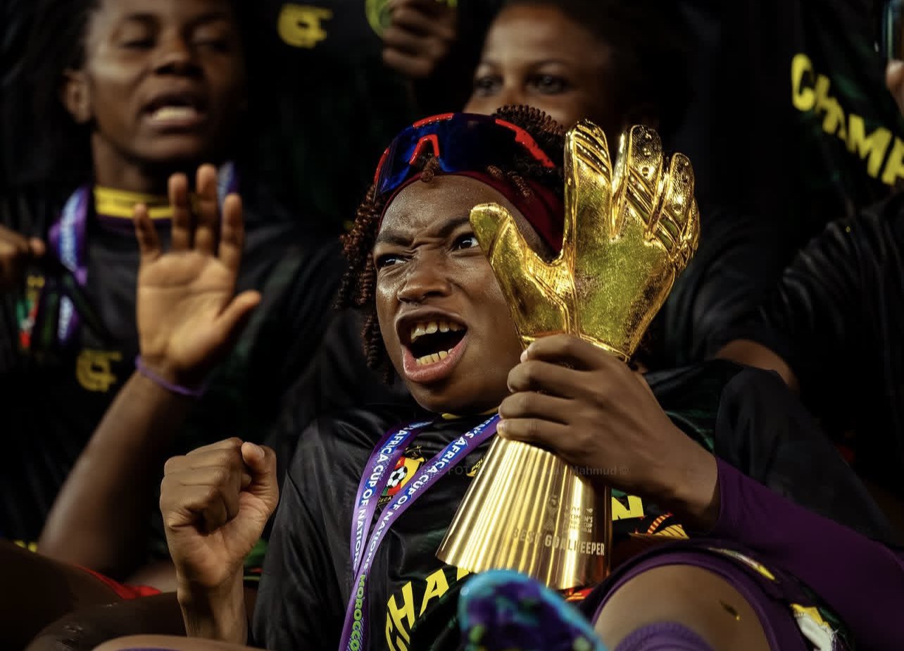 Cameroon goalkeeper Michaely Bihina celebrates passionately with the Best Goalkeeper trophy after winning the Women's Africa Cup of Nations (WAFCON). Image used for Sportxparte news.