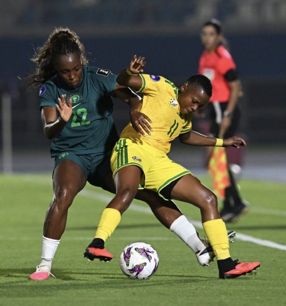 An intense on-field battle features defender Michelle Alozie representing the Nigeria women's national football team (Super Falcons) closed down by forward Thembi Kgatlana of the South Africa women's national football team (Banyana Banyana). Image used for Sportxparte news.