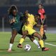 An intense on-field battle features defender Michelle Alozie representing the Nigeria women's national football team (Super Falcons) closed down by forward Thembi Kgatlana of the South Africa women's national football team (Banyana Banyana). Image used for Sportxparte news.