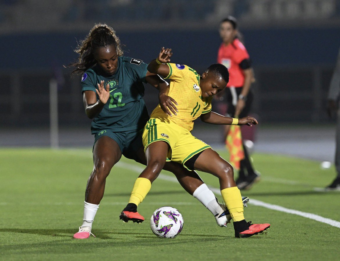 An intense on-field battle features defender Michelle Alozie representing the Nigeria women's national football team (Super Falcons) closed down by forward Thembi Kgatlana of the South Africa women's national football team (Banyana Banyana). Image used for Sportxparte news.