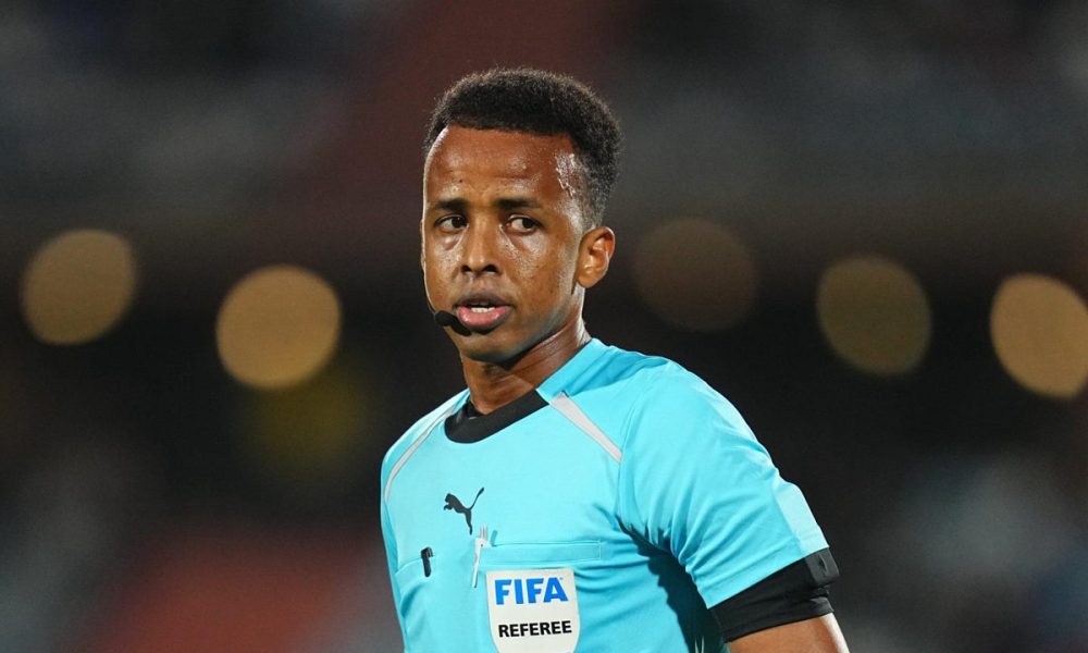 Omar Abdulkadir Artan, a prominent professional football referee from Somalia. He made significant global headlines in June 2026 after being controversially denied entry into the United States by customs officials, which forced him to miss out on officiating at the 2026 FIFA World Cup. Image used for Sportxparte news.