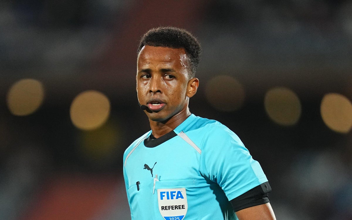 Omar Abdulkadir Artan, a prominent professional football referee from Somalia. He made significant global headlines in June 2026 after being controversially denied entry into the United States by customs officials, which forced him to miss out on officiating at the 2026 FIFA World Cup. Image used for Sportxparte news.