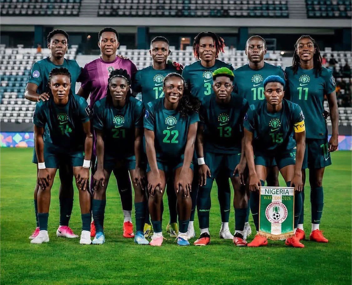 High-quality squad photo of the Nigeria Super Falcons players wearing their iconic green home kits, featuring stars like Chiamaka Nnadozie, Rasheedat Ajibade, and Michelle Alozie during the 2026 WAFCON tournament. Image used for Sportxparte news.